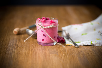 sweet organic smoothie with raspberry on wooden