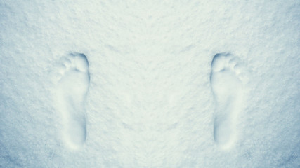 Overhead view of human barefoot footprints on white blue winter snow background. Texture of snow and snowflakes for the New Year, winter holidays