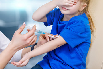 A small child is receiving a preventive vaccination.