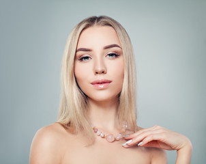 Glamorous jewelry model. Perfect blonde woman with pink gem necklace portrait