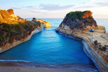 Famous Canal d'Amour beach with beautiful rocky coastline in amazing blue Ionian Sea at sunrise in...