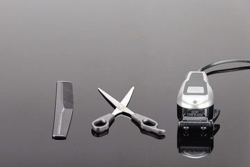 Hair Barber Clippers, Haircut accessories on the grey mirror background with copy space