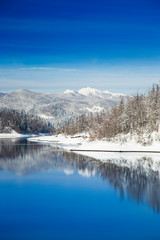 Fototapeta na wymiar Beautiful peaceful lake in mountains in winter, nature landscape in Gorski kotar, Croatia 