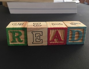 Wooden cubes forming the word Read