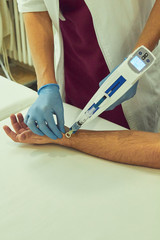Female doctor doing mesotherapy treatment for pain. Beauty and healthcare.