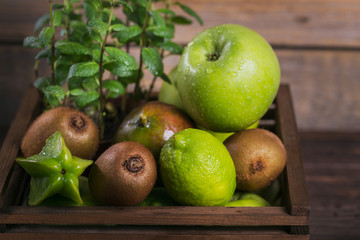 Set of green fruits for healthy diet and detox: apple, lime, kiwi, mango, carambola and mint.