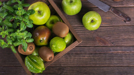Set of green fruits for healthy diet and detox: apple, lime, kiwi, mango, carambola and mint.