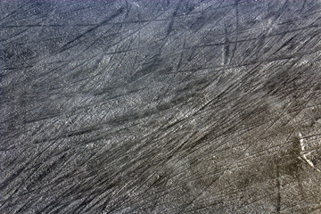 Ice rink covered with snow and faded with ice skates