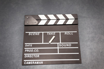 Fototapeta na wymiar Movie clapper board on gray background - film concept