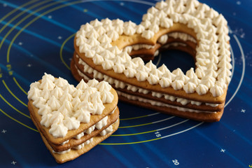 Assembling a heart-shaped cakes using butter cream. Valentine's Day, Birthday Cake, March 8th and Mother's Day