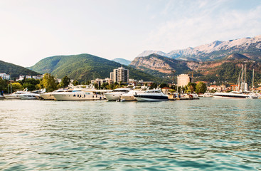 Marina for sailing yachts and boats with a view of the city of Budva and the Balkan Mountains, Budva Riviera, Montenegro.