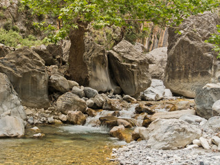 Crystal clear water of a cold mountain creek at rocky terrain of Samaria gorge, south west part of...