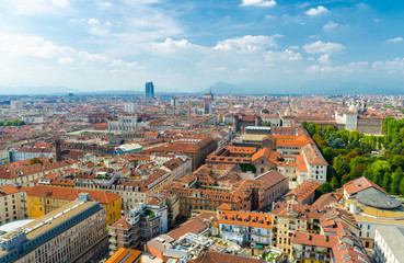 Fototapeta na wymiar Aerial top panoramic view of Turin city historical centre, Royal Palace, Palazzo Carignano, San Lorenzo church, orange tiled roofs of buildings, sightseeings with Alps mountain range, Piedmont, Italy