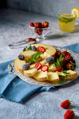 Tray with fruit and berries and lemonade