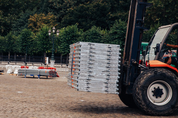 Forklift delivers metal profile from warehouse for construction of building