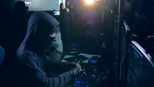 Male hacker working with computer. Cyber attack concept.