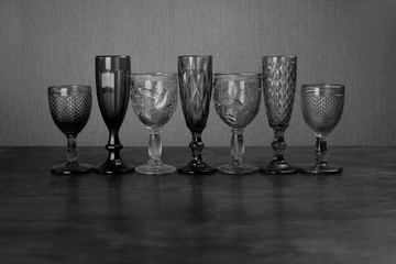 seven glasses for alcoholic drinks black and white photo