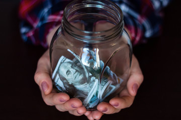 holding out a jar for donation