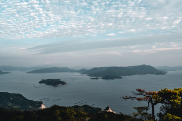 Beautiful view on trees and cloudy sky and pearl farms from Mount Misen at Miyajima island in...