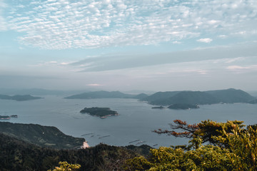 Beautiful view on trees and cloudy sky and pearl farms from Mount Misen at Miyajima island in...