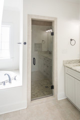 Fototapeta na wymiar Modern New Construction White Clean Master Bathroom Shower