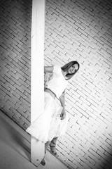 girl on the stairs with brick wall blakc and white