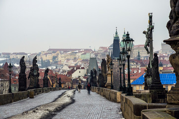 Prague, Czech Republic, 26.12.2014. "Karluv most" or Charles bridge, the statues and the view over Mala Strana and Prague castle on a cloudy winter day