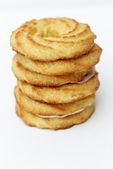 Coconut biscuit rings on white linen background