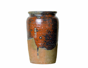 An old handmade caramic crock partly glazed on outside surface isolated on white background