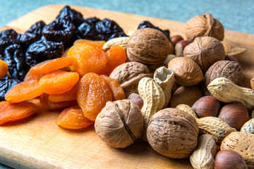 vegetarian food of nuts and dried fruits on the kitchen board