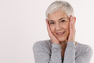 Happy Smiling Mature Woman Portrait on white background. Older skin care, beauty concept.