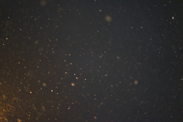 Night dark sky and snow flakes. Night landscape. Falling snow in the light of street lamps at night. 