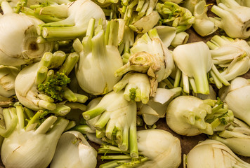 fresh juicy fennel bulbs on the market background texture