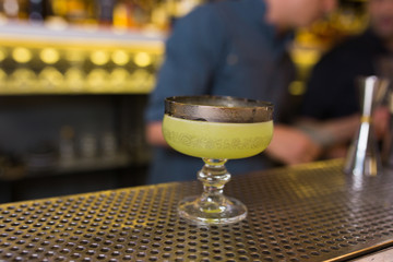 Green White Cocktail drink -beverage on a bar counter .  Selective focus on the foreground glass, Top view . Trendy stylish edit . Copy paste space for design concept service barmen concept