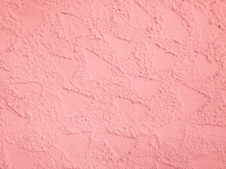 Rosa strukturierte Wand einer Hausmauer