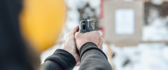 Shooting on target in shooting range. Back close-up detail view