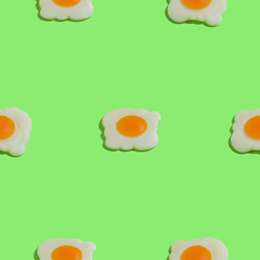 Creative seamless pattern with scrambled eggs on green background. Food abstract background
