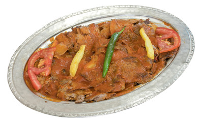 Traditional Turkish Doner Kebab Iskender on copper plate isolated on white
