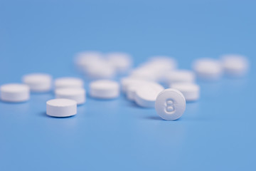 White pills or capsules on a blue background