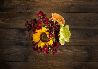Bouquet of flowers on a wooden table background. Vintage floral background with spring flowers. Copy space