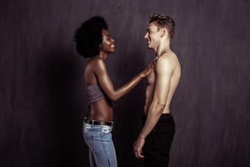 Fototapeta na wymiar Positive afro American woman touching her boyfriend