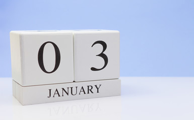 January 03st. Day 03 of month, daily calendar on white table with reflection, with light blue background. Winter time, empty space for text