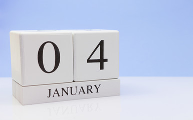 January 04st. Day 04 of month, daily calendar on white table with reflection, with light blue background. Winter time, empty space for text