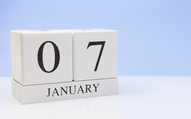 January 07st. Day 07 of month, daily calendar on white table with reflection, with light blue background. Winter time, empty space for text