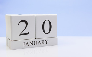 January 20st. Day 20 of month, daily calendar on white table with reflection, with light blue background. Winter time, empty space for text