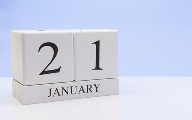 January 21st. Day 21 of month, daily calendar on white table with reflection, with light blue background. Winter time, empty space for text