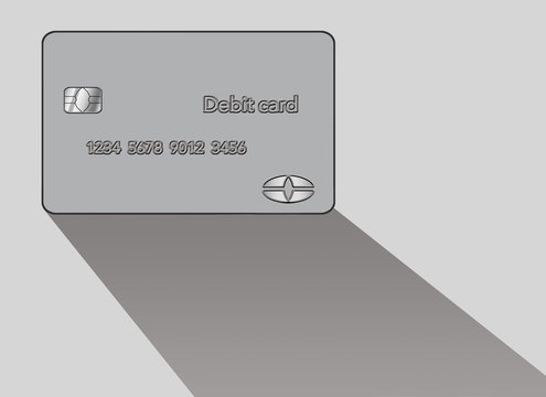 A debit card casts a shadow in this minimalist image with limited color mixed with grey, blacks and whites.