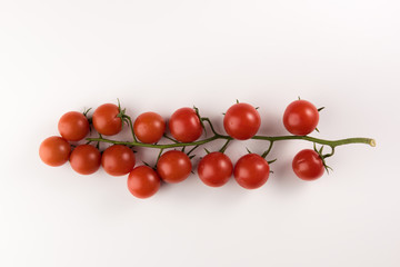 Cluster of cherry tomatoes on the white isolated background, flat lay