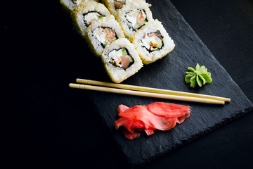 Sushi rolls on a black plate. Japanese food.