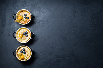 Classic English rice pudding. Dark background, top view, space for text